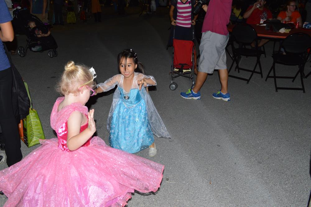 Girl dressed in blue dress and girl dressed in pink dress play